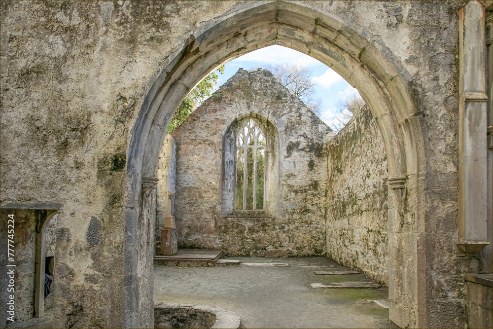 Looking through the archway of a derelict abbey at a gable end