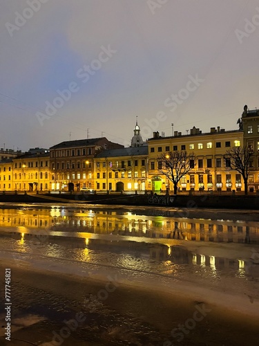iced city river, city buildings reflection on the iced city river, night illumination  © Oksana
