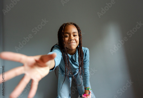 Portrait of 11 year old girl smiling to camera over grey background photo