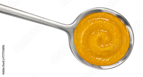 Spoon of pumpkin cream soup isolated on white background. Top view
