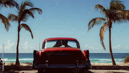 Kissing couple in Classic red car parked by the shore, evoking nostalgia and summer vibes with its vintage charm against a backdrop of palm trees and ocean waves. Traveling and retro dating convept. © Train arrival