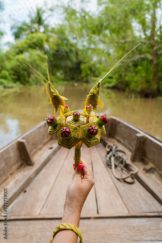 Woman holding a bouquet flowers during a boat trip along a river