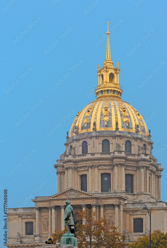 Dome des Invalides with statue of Fayolle in front against blue sky on an clear day in November in Paris, France