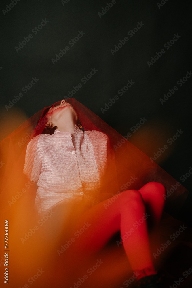 A Woman Lying Down covered with red tulle A Woman Lying Down covered with red tulle