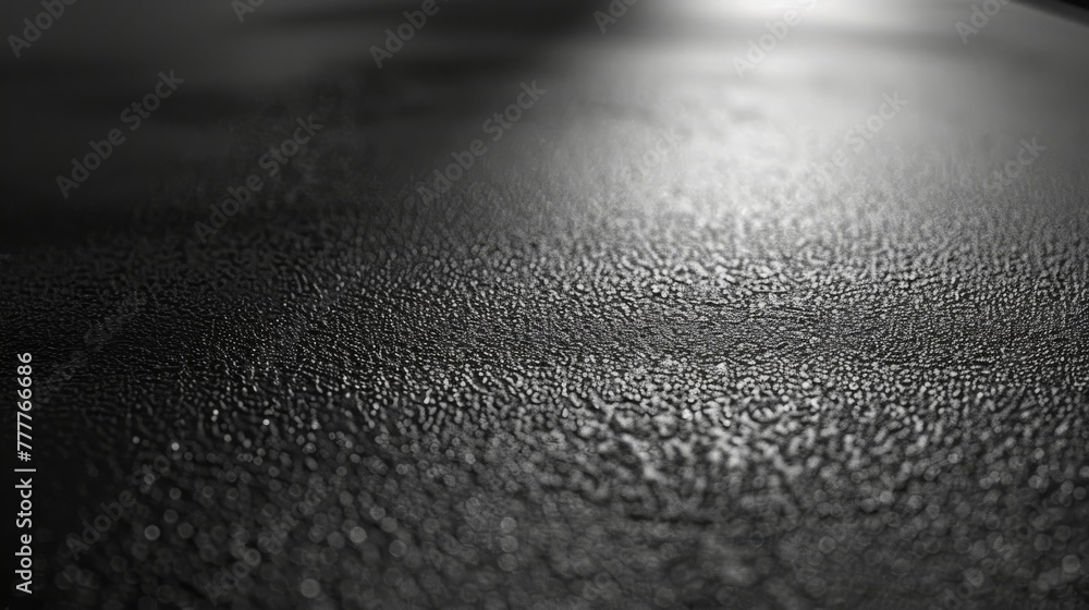 Textured surface with a soft gradient of light creating a highlight on the material's details. Detailed monochromatic texture in a grayscale photo Textured surface with a soft gradient of light creating a highlight on the material's details. Detailed monochromatic texture in a grayscale photo
