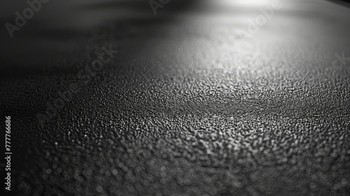 Textured surface with a soft gradient of light creating a highlight on the material's details. Detailed monochromatic texture in a grayscale photo