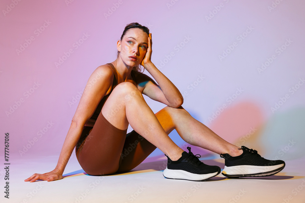 © BONNINSTUDIO/Stocksy - Woman in trendy outfit in colorful wall © BONNINSTUDIO/Stocksy - Woman in trendy outfit in colorful wall