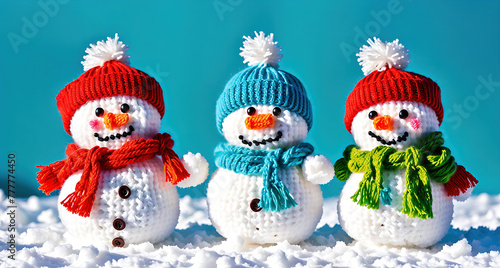 Three snowmen wearing hats and scarves, standing in the snow.