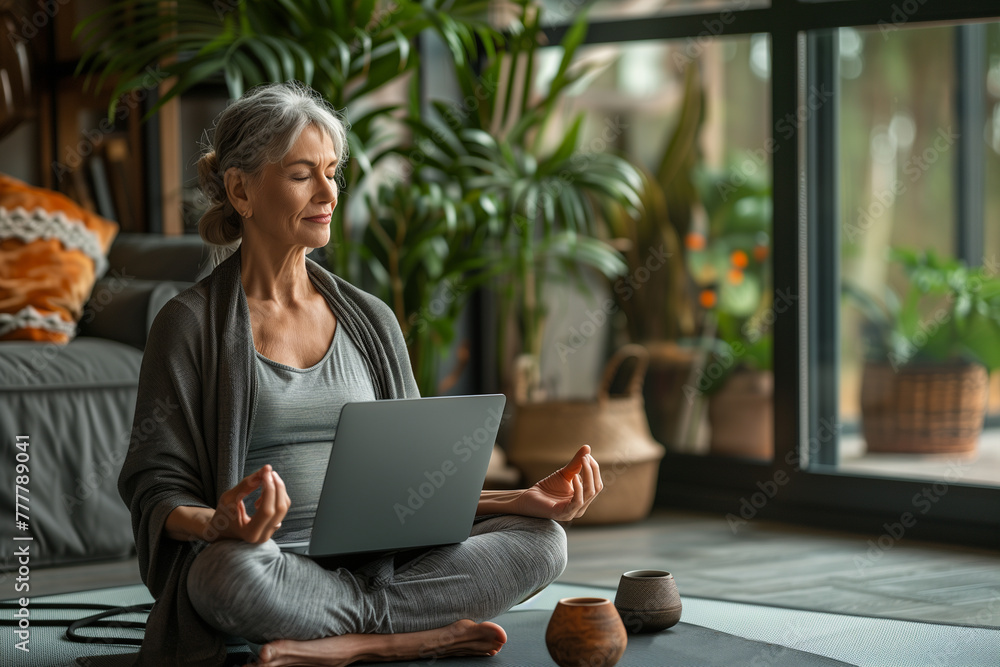 Woman Sitting on Yoga Mat Using Laptop