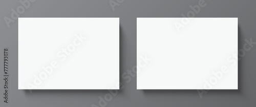 2 blank white paper posters hanging on a grey wall background. Poster gallery vector mockup for horizontal art, image, or text placement. © Topuria Design