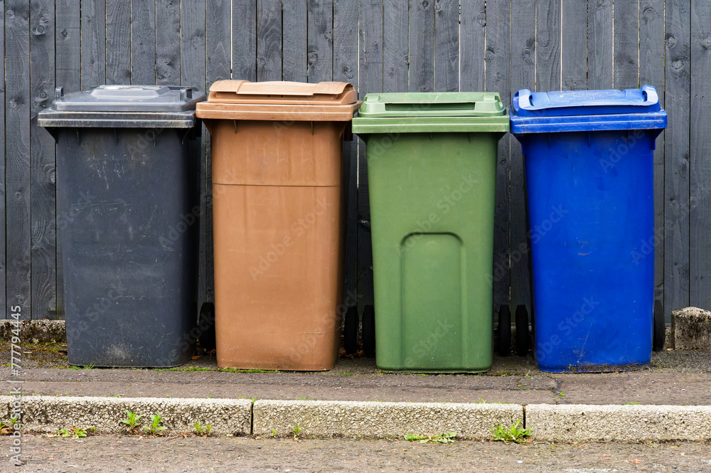 Wheelie bins in row segregated for recycling rubbish Wheelie bins in row segregated for recycling rubbish