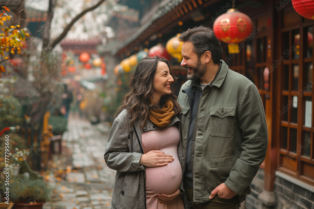 Expectant Couple Embracing in a Lantern-Adorned Alley Expectant Couple Embracing in a Lantern-Adorned Alley