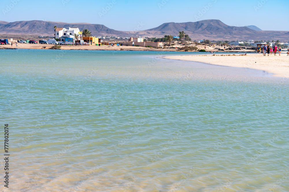 Obraz premium West coast of Fuerteventura island. Winter sea and sun vacation in El Cotillo touristic village, Canary islands, Spain. White sandy beach La Concha..