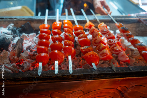 Barbecue with ripe red tomatoes on charcoal grill in turkish restaurant