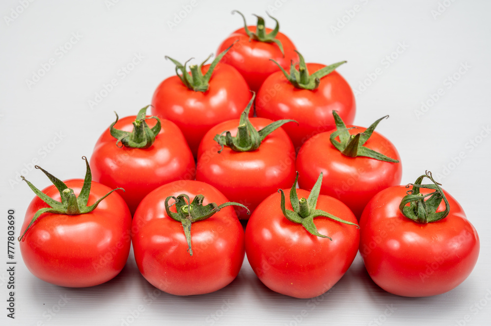 Food triangle, Red ripe tasty Dutch tomatoes, vegetables background top view close up copy space Food triangle, Red ripe tasty Dutch tomatoes, vegetables background top view close up copy space