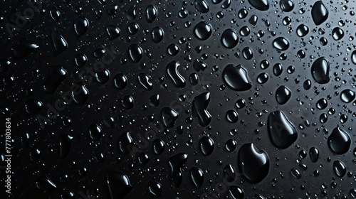 Condensation water drops on a dark glass texture background. Shower or rain droplets, pure aqua blobs. Top view