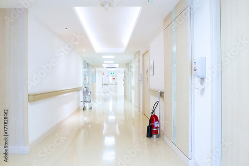 Corridor in hospital with vital signs patient monitor and  fire exit sign