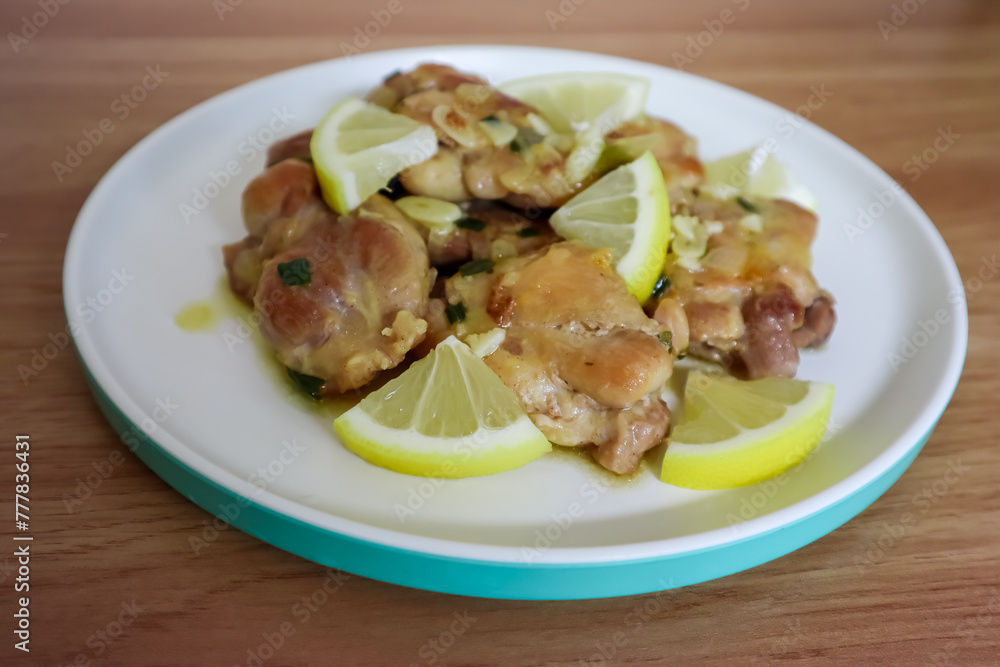 Lemon butter chicken served on plate, ready to eat Lemon butter chicken served on plate, ready to eat