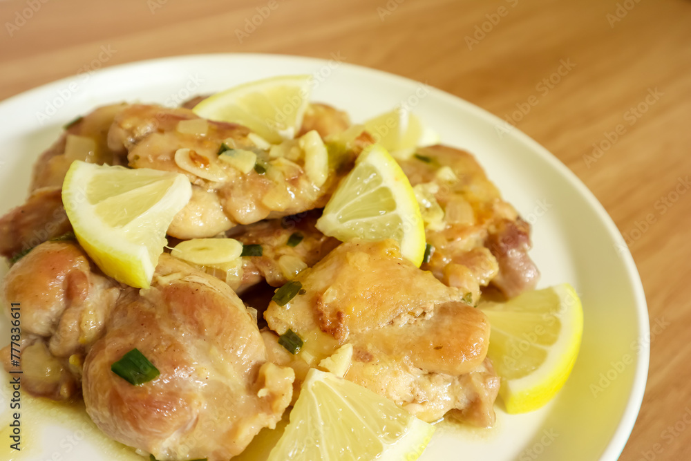 Lemon butter chicken served on plate, ready to eat Lemon butter chicken served on plate, ready to eat