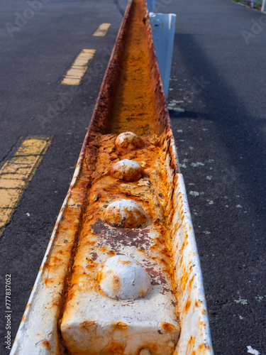 Along a rusty metal railing