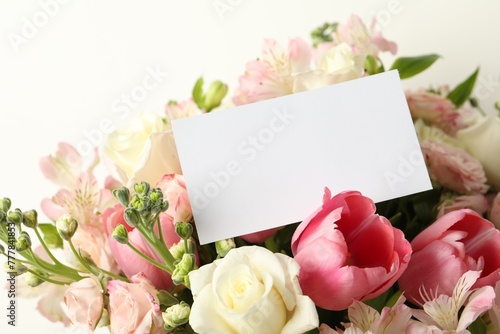 Happy Mother's Day. Beautiful flowers with blank card on light background, closeup