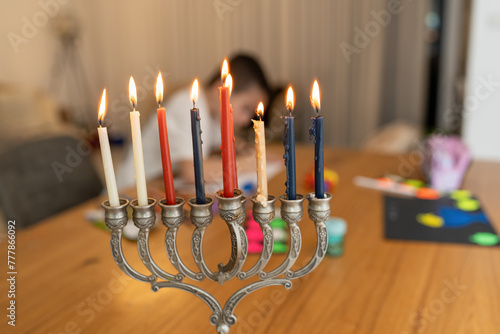 Traditional Menorah, Boy Drawing Holiday Hanukkah Card in Background. photo