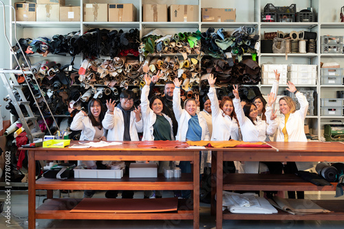 Happy diverse colleagues sitting at tables for group picture photo