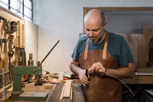 Luthier Repairing a guitar photo