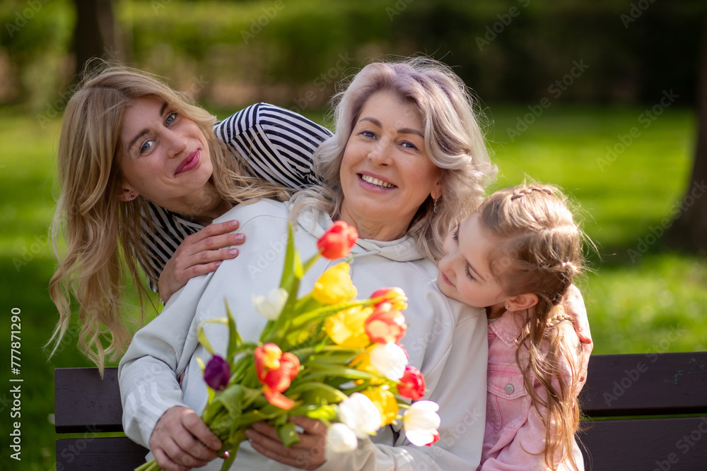 Three generations family with tulip bouquet Three generations family with tulip bouquet