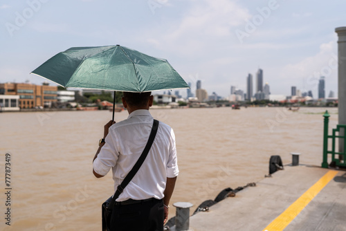 Man at the river in the city of Bangkok. photo
