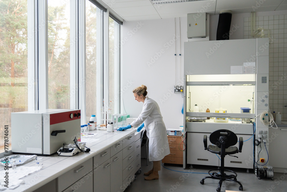 Busy Female Scientist In Modern Spacious Lab Busy Female Scientist In Modern Spacious Lab
