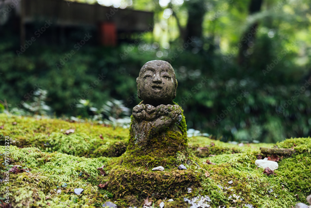 Stone Jizo Statue in Mossy Garden Stone Jizo Statue in Mossy Garden