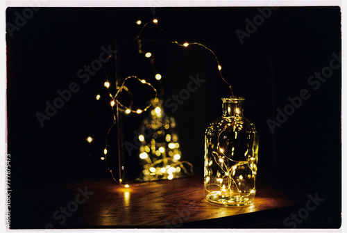 Festive LED string lights inside of a clear bottle photo