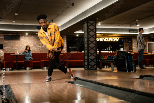 A man is playing bowling photo