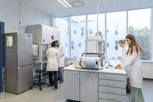 Many Researchers Working In Bright Lab Room photo