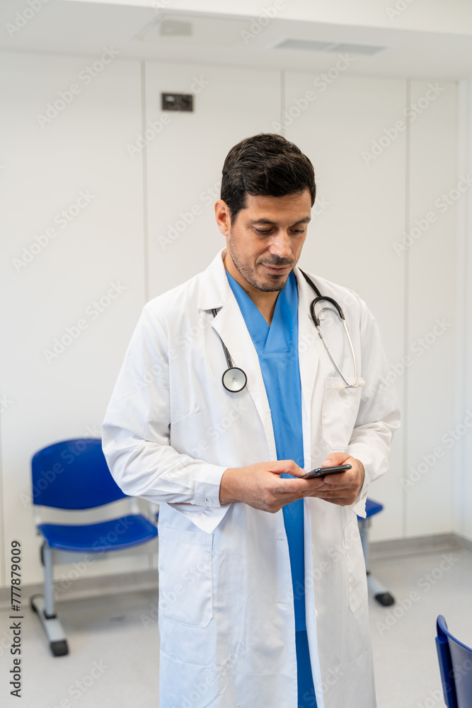 Portrait of a male doctor using mobile phone in the hospital. Portrait of a male doctor using mobile phone in the hospital.