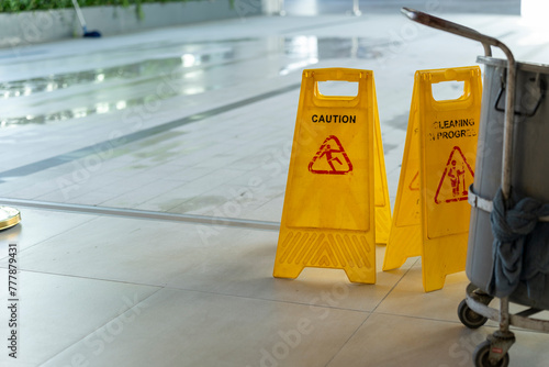 Two Yellow caution wet floor sign on Wet floor