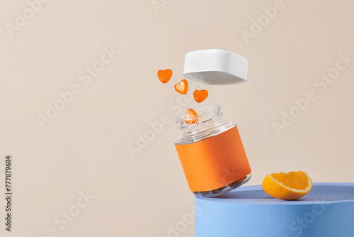 Plastic bottle with gummy  jumping out and citrus fruits photo