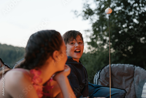 Friends around campfire at night. photo