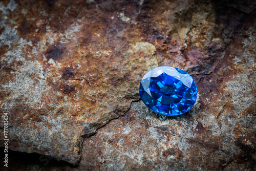 Natural blue sapphire on stone background