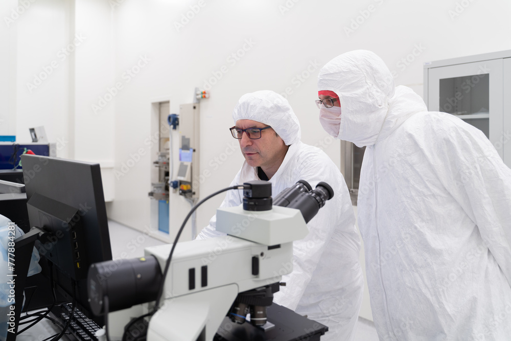 Two Researchers Working At Clean Room Two Researchers Working At Clean Room