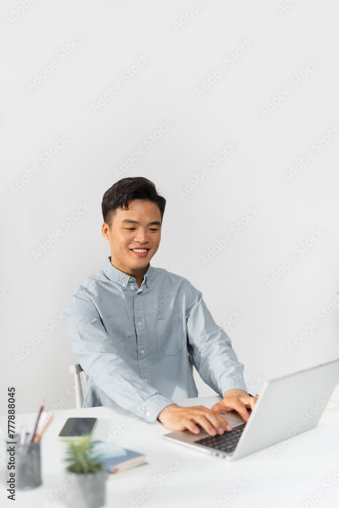 Young businessman working in the office, sitting at desk Young businessman working in the office, sitting at desk