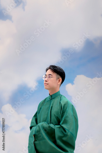 Portrait of Asian Man in Traditional Vietnamse Ao Dai photo