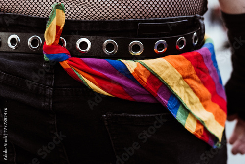 Unrecognisably man with a scarf in lgbt colours tied to his belt photo