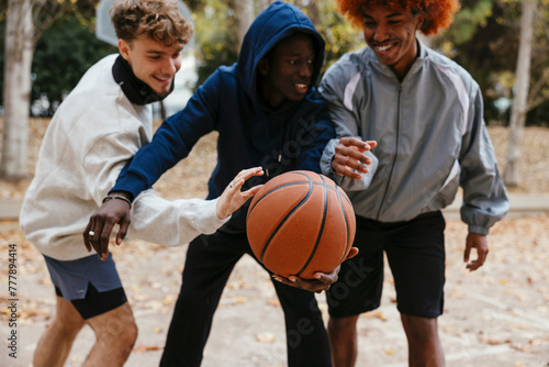 Group Of Friends Having Fun Together At An Outdoor Basketball Court photo