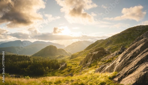 landscape of mountains and green hills summer nature landscape with rocks forest grass sun sky and clouds national park or reserve