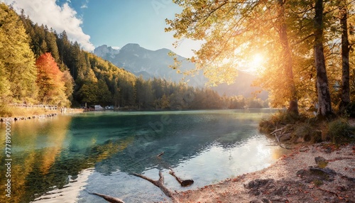 awesome sunny landscape in the forest wonderful autumn scenery picturesque view of nature wild lake sun rays through colorful trees incredible view on fusine lakeside amazing natural background
