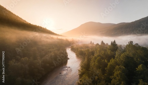 drone photo of foggy forest river in the mountains