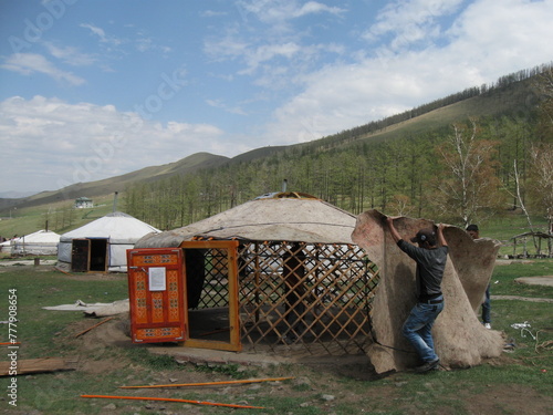 A nomadic family sets up their nomadic tent (ger) in the silent steppe of Bogd Khaan Uul valley, Ulaanbaatar region, Mongolia. The valley is so tranquil and bit windy. Some nomads live around there. 