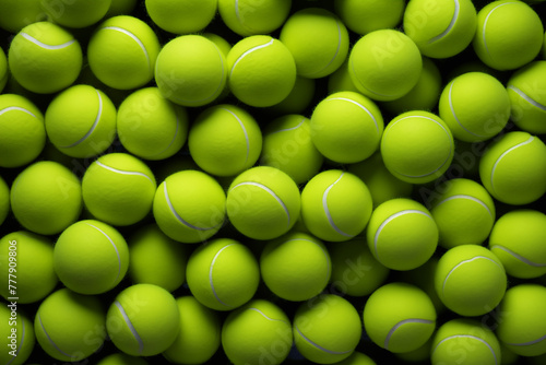 Close up of the vibrant tennis balls await their turn in the game on background. © h3bs